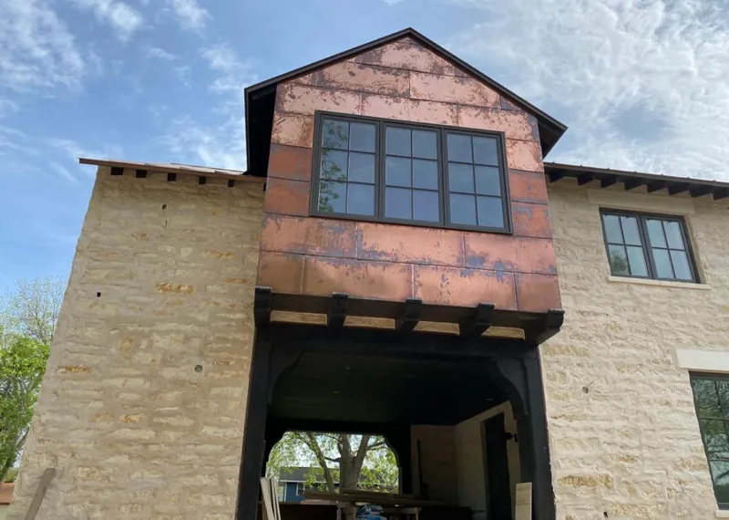 Copper metal panel facade on a stone building for Skylight Installation in Oak Park